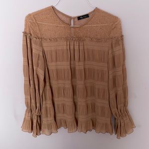 Blouse with ruffles. Very flattering. True to size.